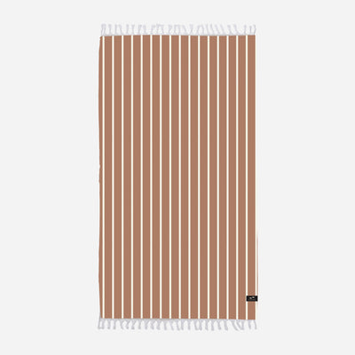 Towel with terracotta stripes and white fringe on edges.