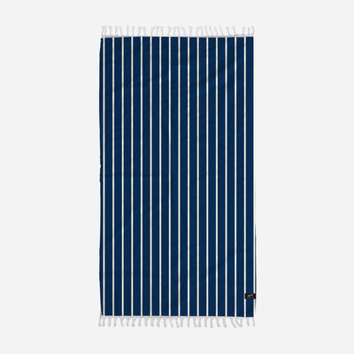 Beach towel, lightweight with navy pinstripes, white stripes, and fringed edges.