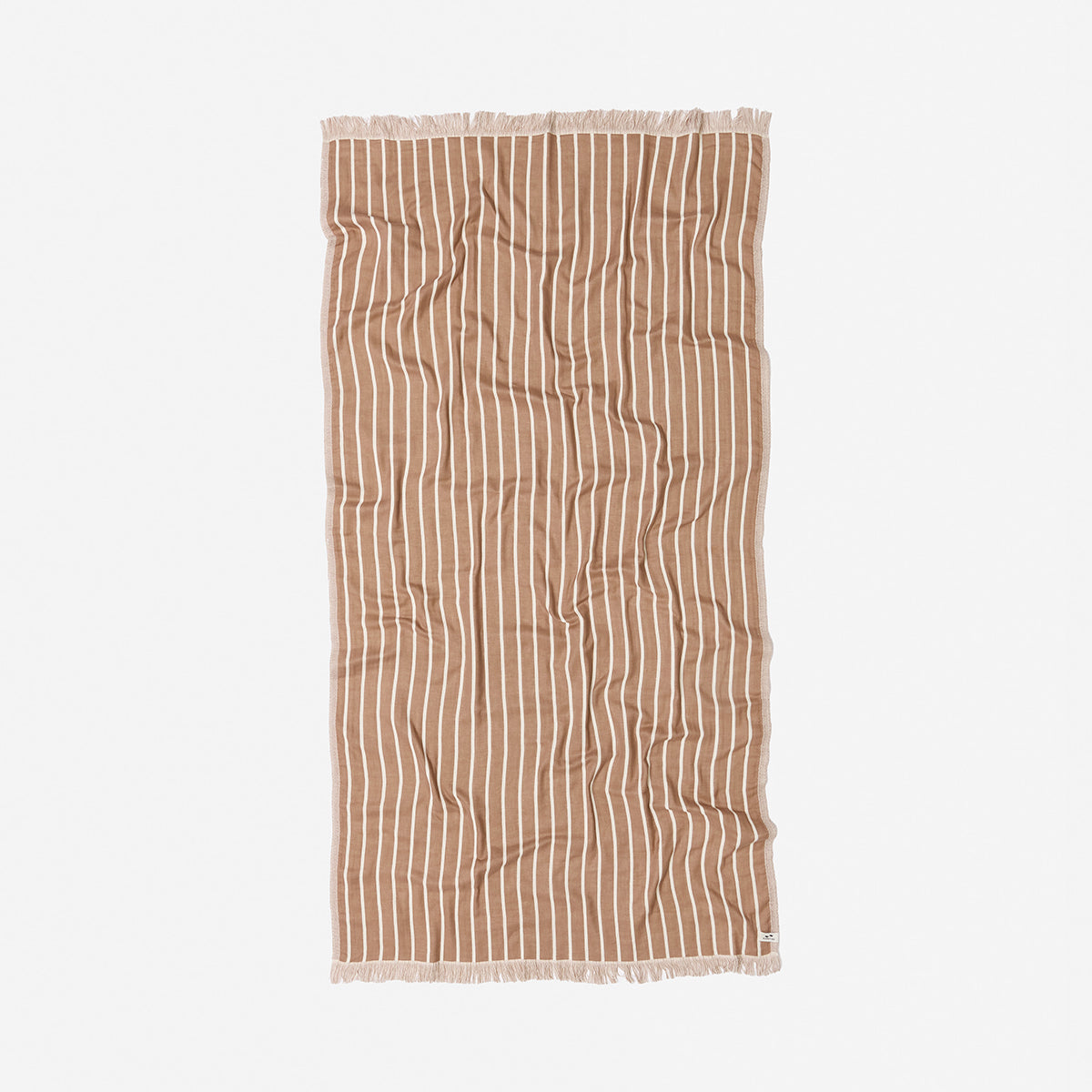Oversized terracotta towel with white stripes and fringed edges on a plain background.