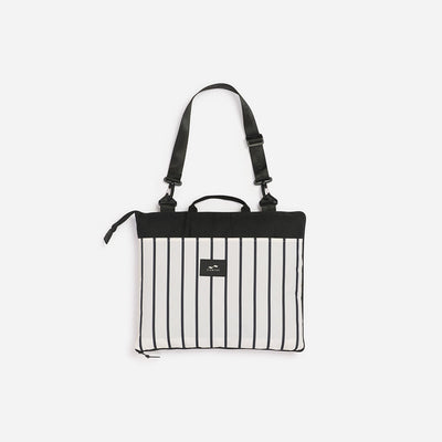 Foldable picnic blanket with black and white vertical stripes and a black top panel.