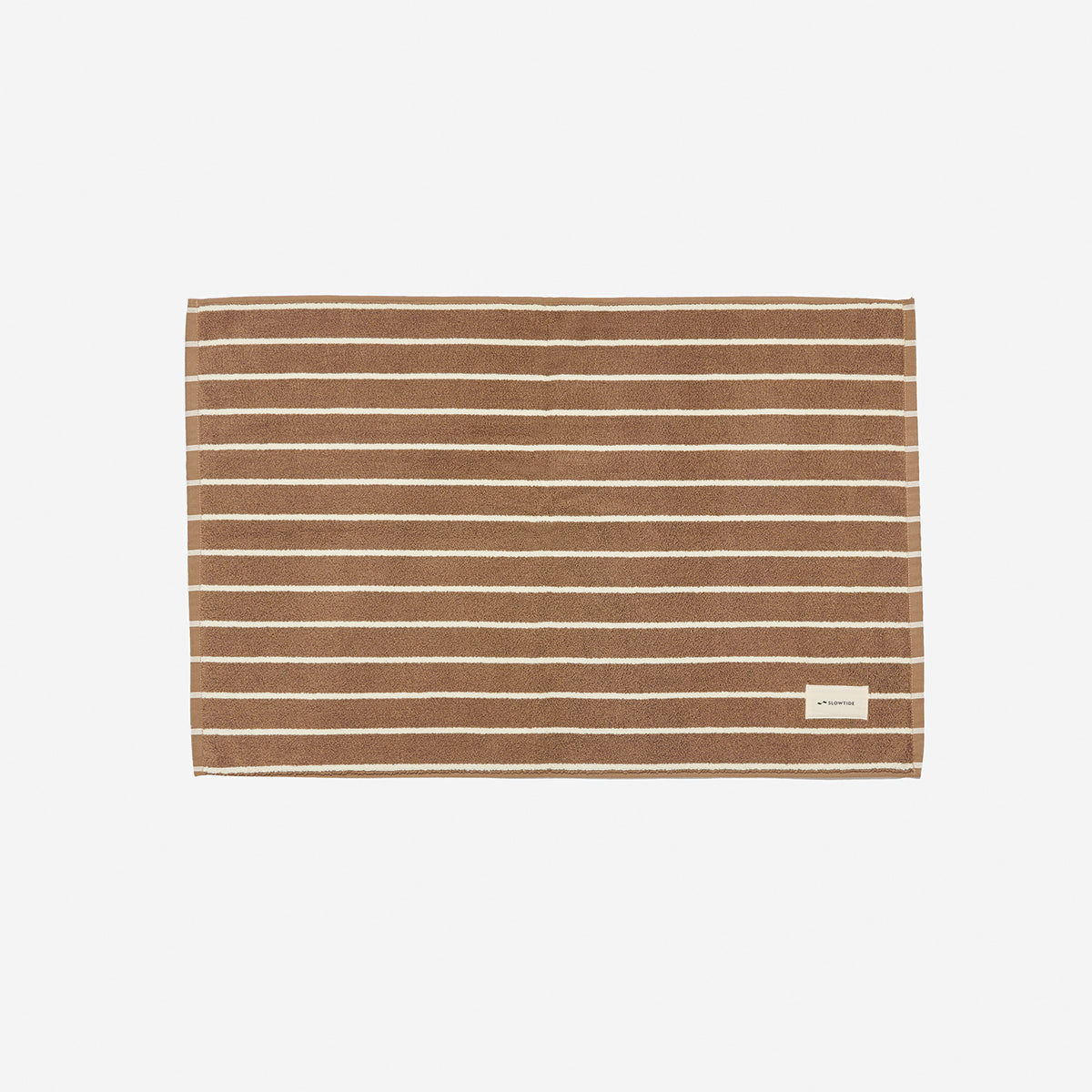 Brown cotton towel with white stripes, absorbent, sustainable material.