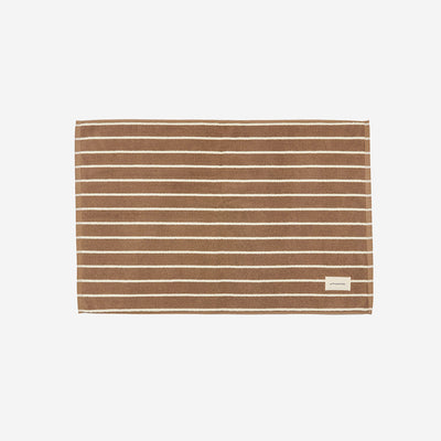 Brown cotton towel with white stripes, absorbent, sustainable material.