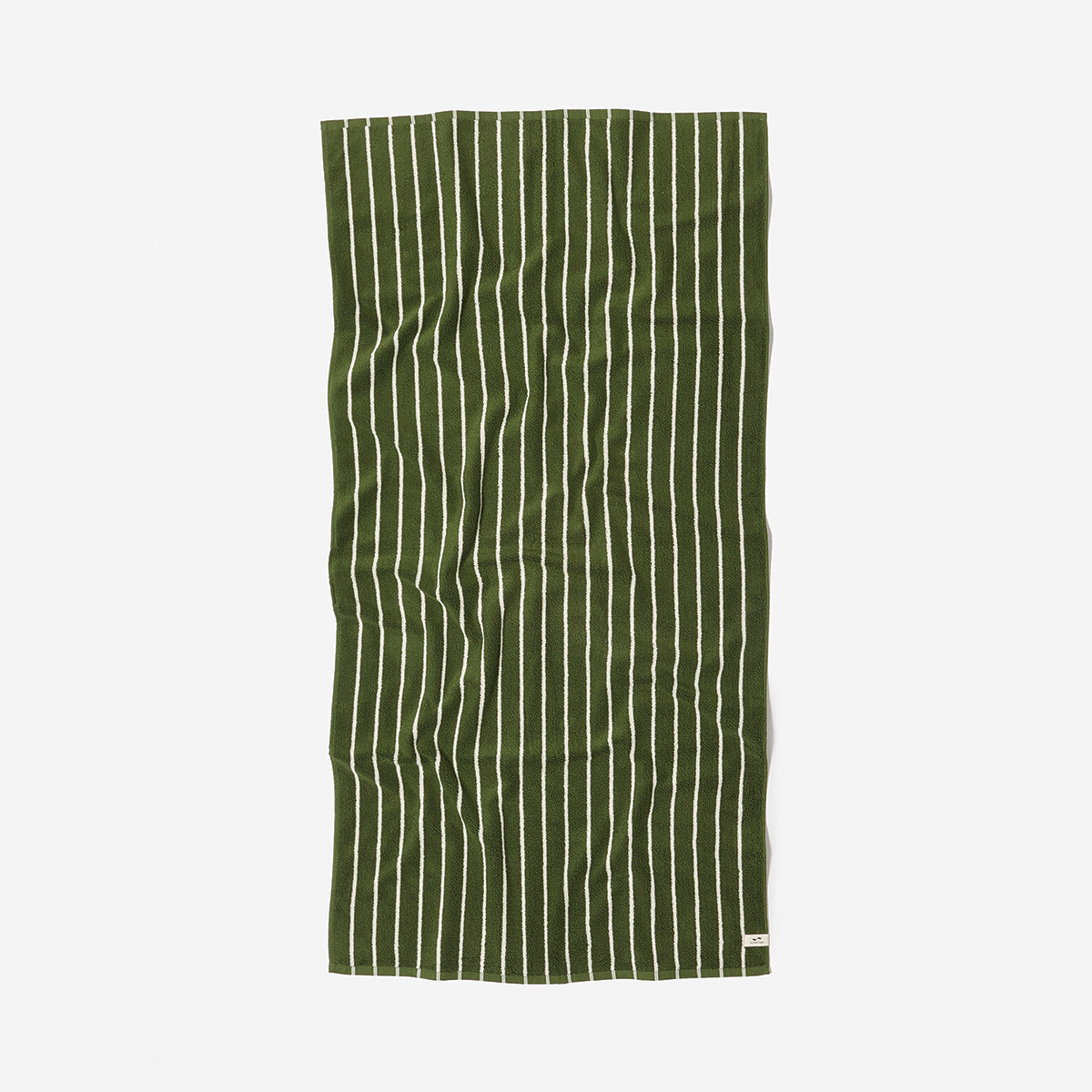 Sand resistant towel with green and white vertical stripes, slightly wrinkled.