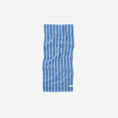 Blue quick dry towel with white vertical stripes, shown flat on a plain background.