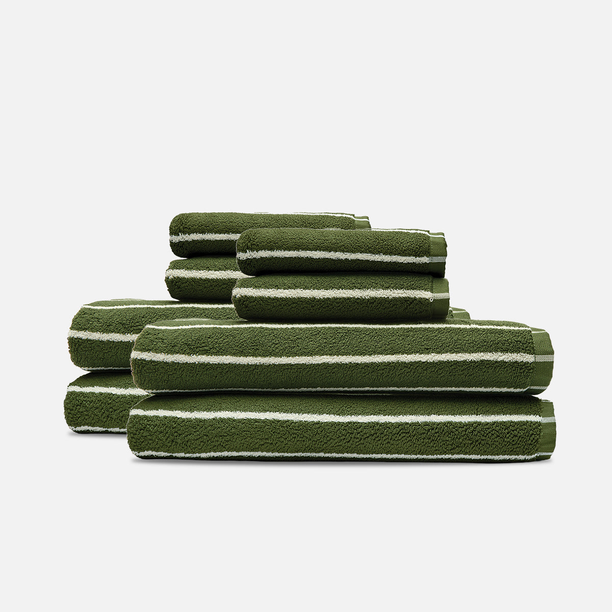 Plush green and white bath towels stacked in three rows.
