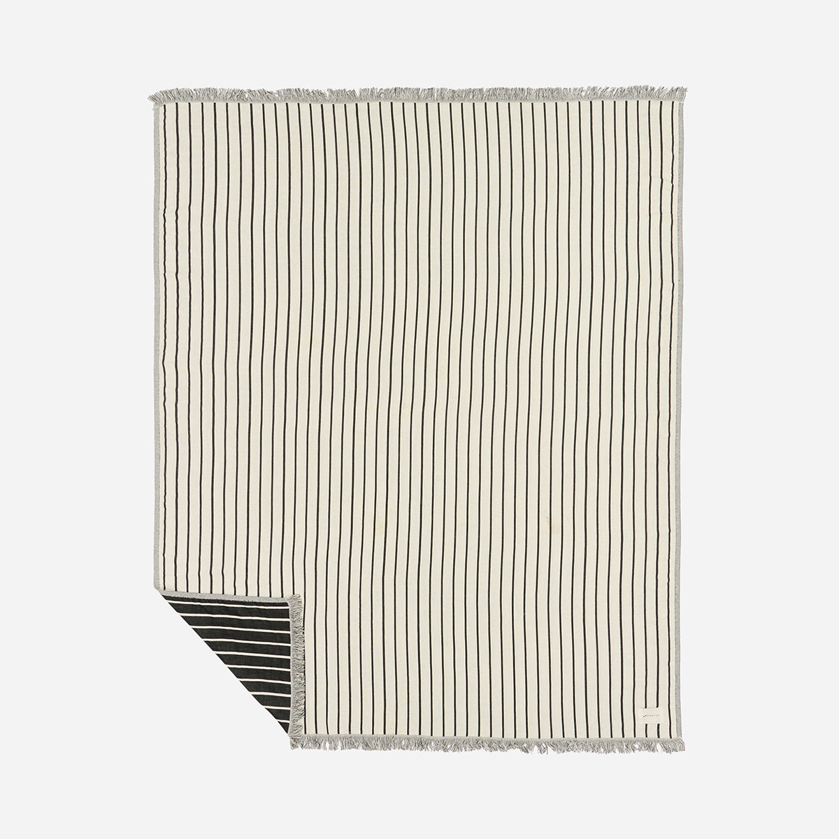 Cotton blanket with thin black stripes, fringed edges, and visible reverse corner.