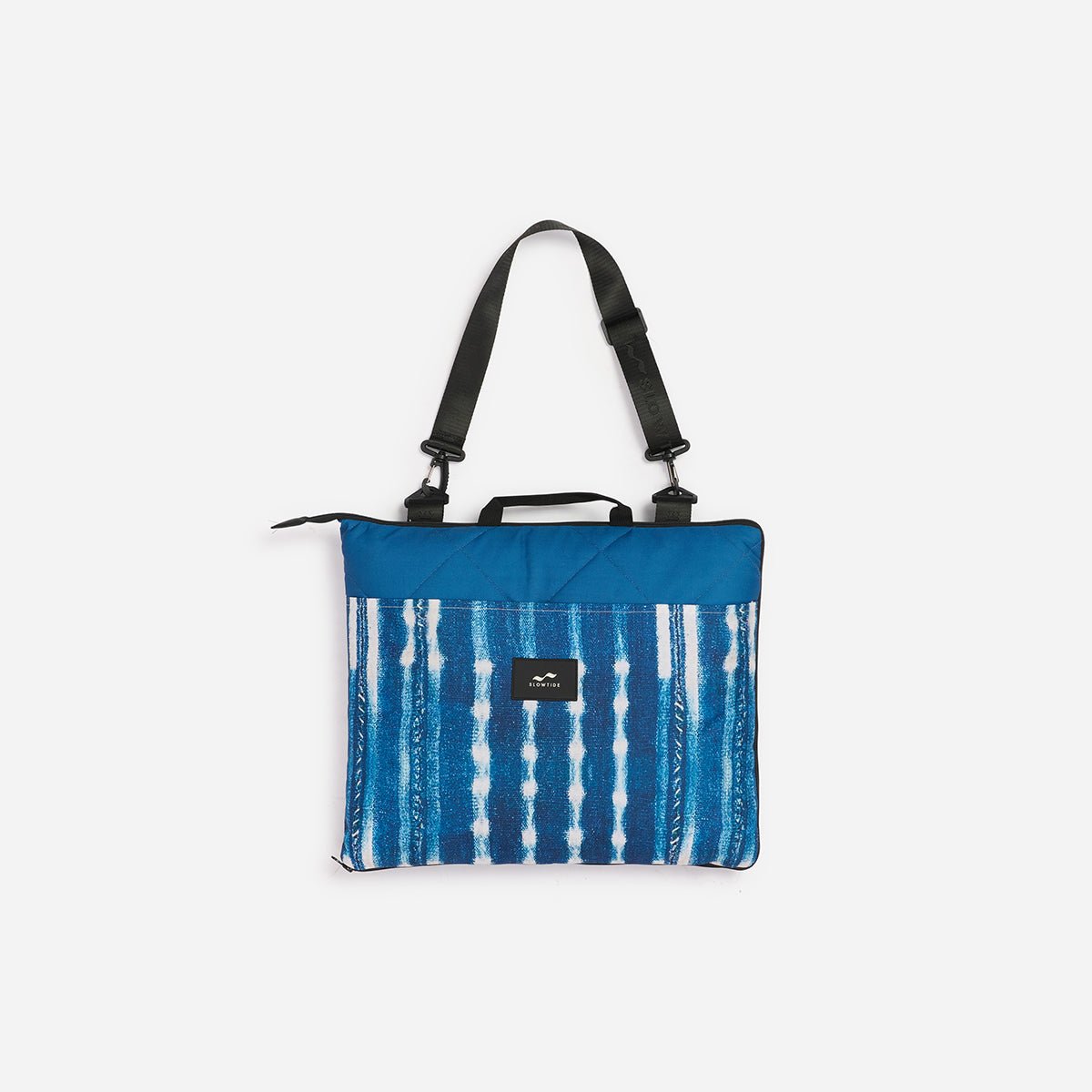 Blue and white patterned bag with a black strap on a white background