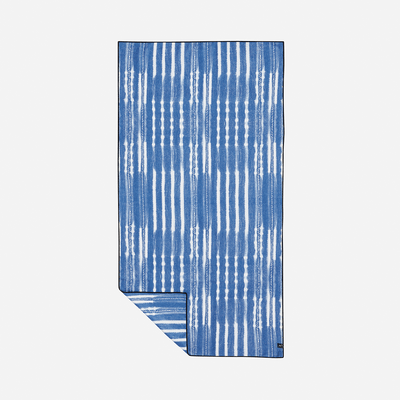 Beach towel, quick-drying fabric with blue and white vertical stripes, folded corner.