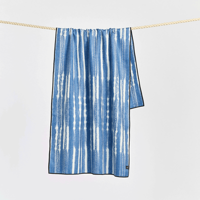 Beach towel, quick-drying fabric, blue and white stripes, hanging on rope.