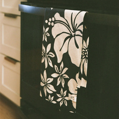 Kitchen towel, recycled microfiber, black and white pattern, hanging on oven door.