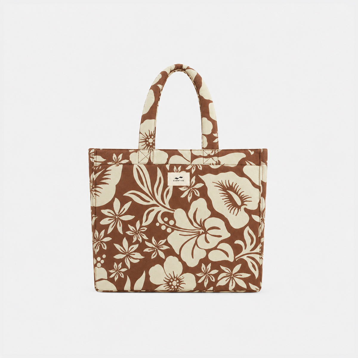Tote bag in sustainable cotton with beige floral pattern and two handles.