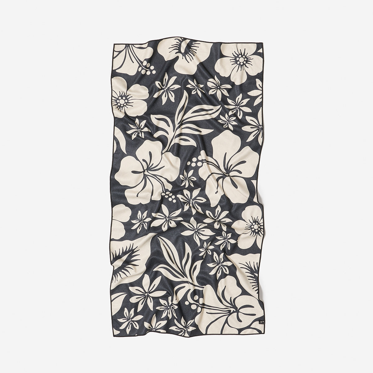 Recycled black and white towel with large floral pattern, slightly wrinkled.