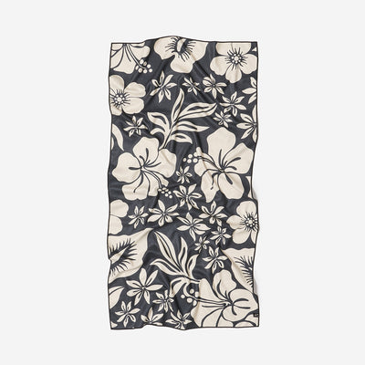 Recycled black and white towel with large floral pattern, slightly wrinkled.