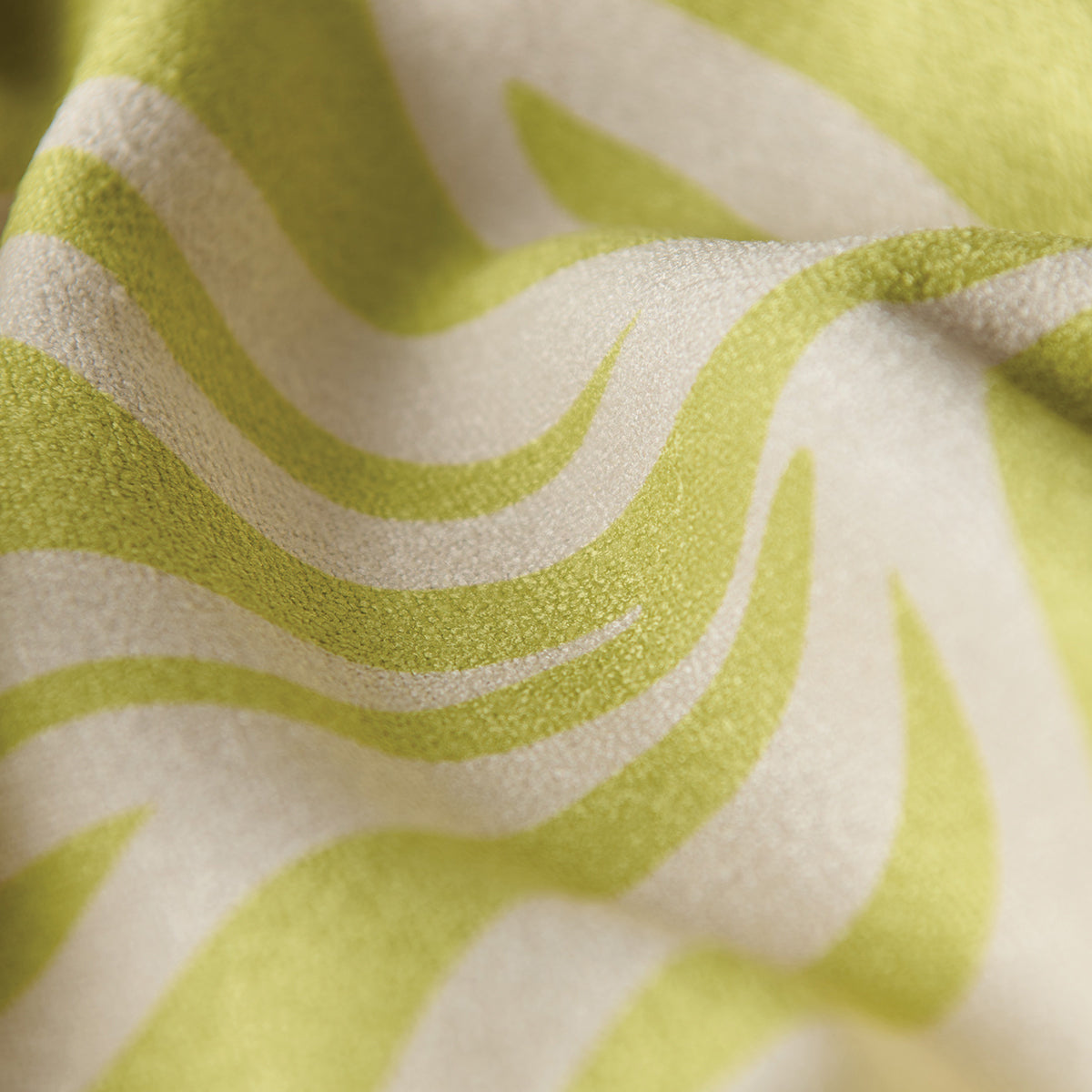 Quick-drying towel with wavy light green and cream textured pattern, close-up view.