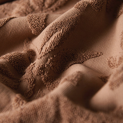 Fabric, sustainable cotton with brown wavy textured pattern, for textiles or upholstery.