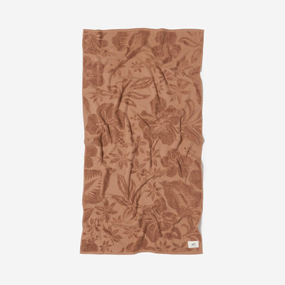 Brown cotton towel with floral pattern, absorbent and sustainably sourced.