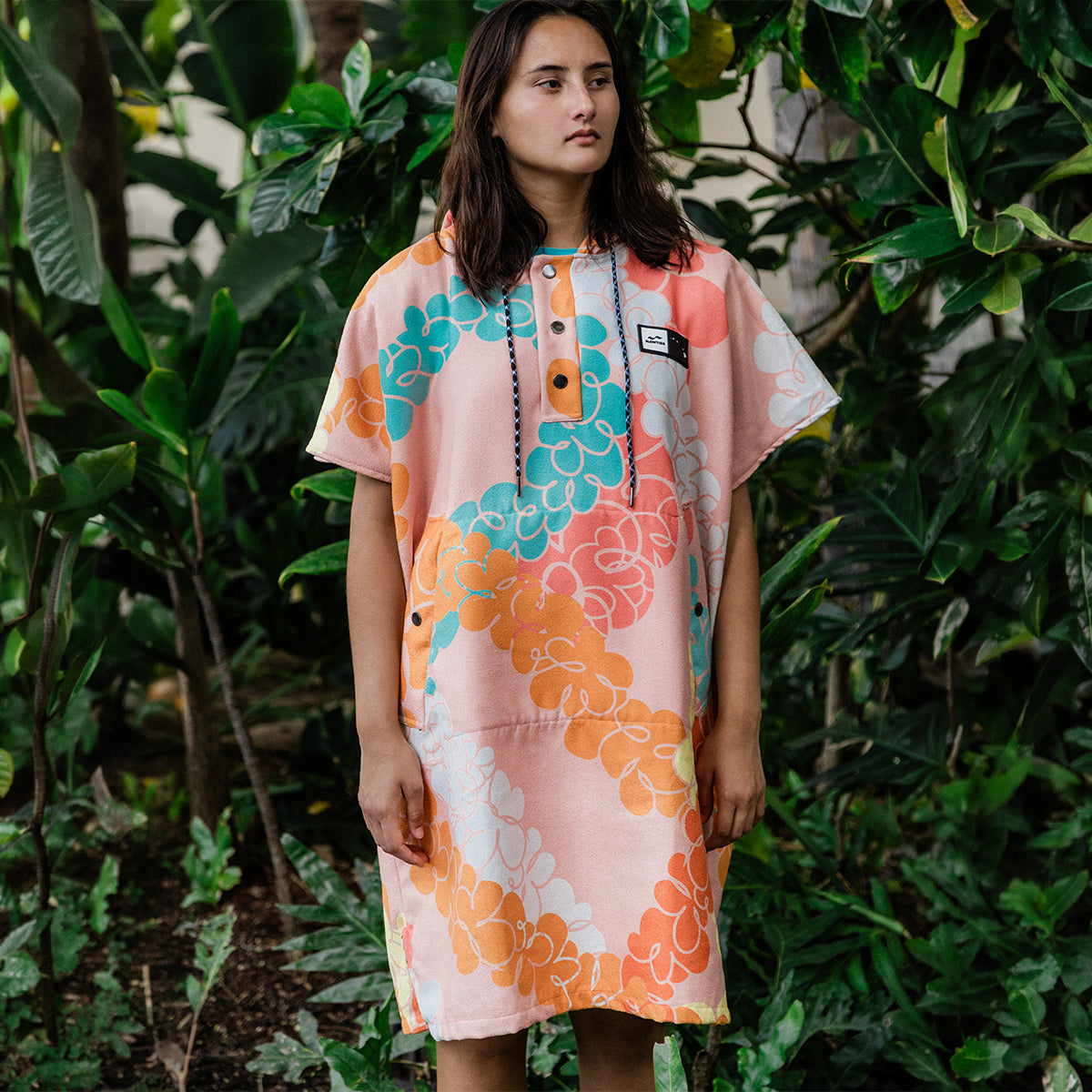Colorful sustainable changing poncho with multicolor pattern.