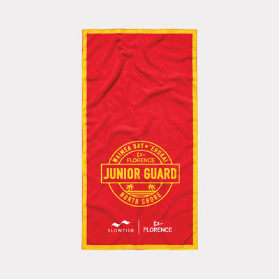 Junior Guard beach towel in red with yellow trim and quick-dry fabric.