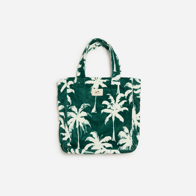 Green cotton tote bag with white palm tree print, sustainable material.