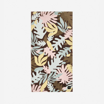 Beach towel with pastel tropical leaf pattern on brown background, made from sustainable materials.
