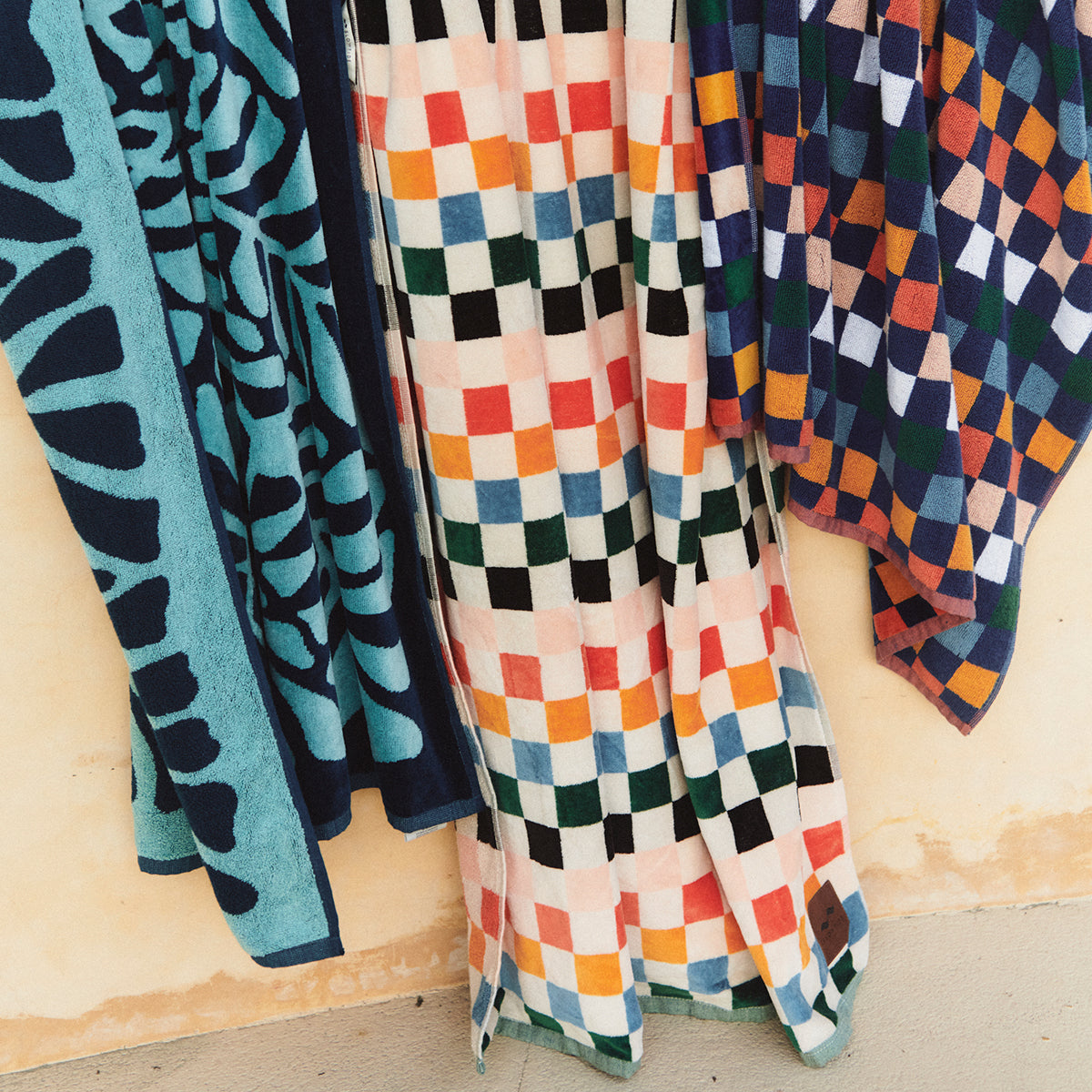 Jacquard weave towels with colorful patterns displayed side by side.