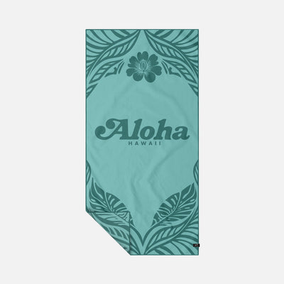 Quick-drying teal towel with floral and leaf pattern, Aloha Hawaii text.