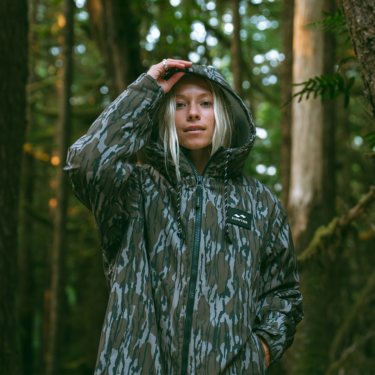 Insulated jacket with hood in outdoor setting.