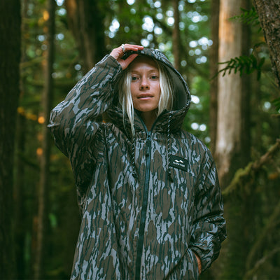 Insulated jacket with hood in outdoor setting.