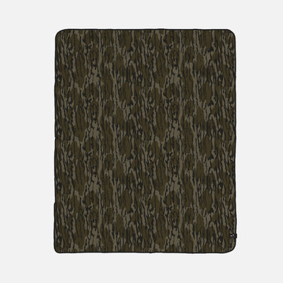 Camouflage all-weather blanket with green and brown pattern, rectangular shape.