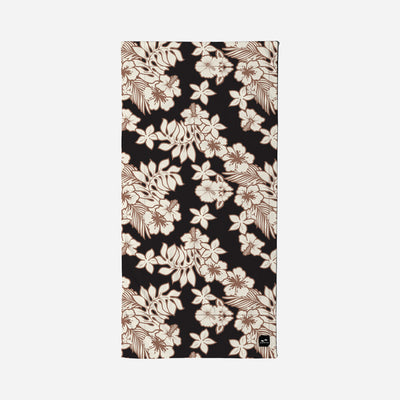 Beach towel, plush velour, beige and brown tropical floral pattern on black background.
