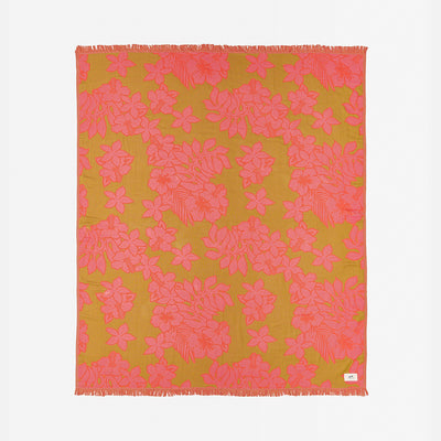 Beach towel, lightweight fabric with pink floral pattern and fringed edges displayed flat.