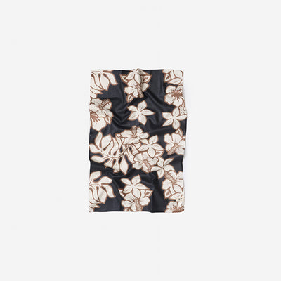 Quick dry black towel with beige floral and leaf print, flat display.