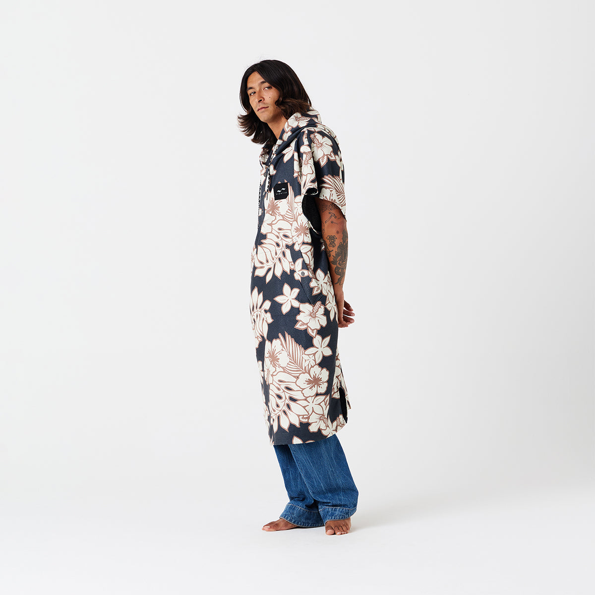 Shirt dress with floral print layered over jeans.