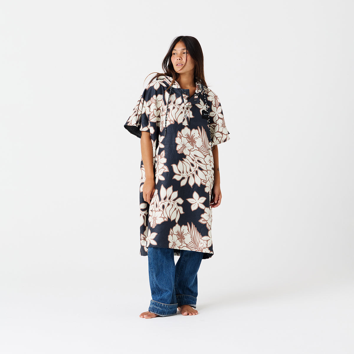 Floral print quick-dry poncho over blue jeans.