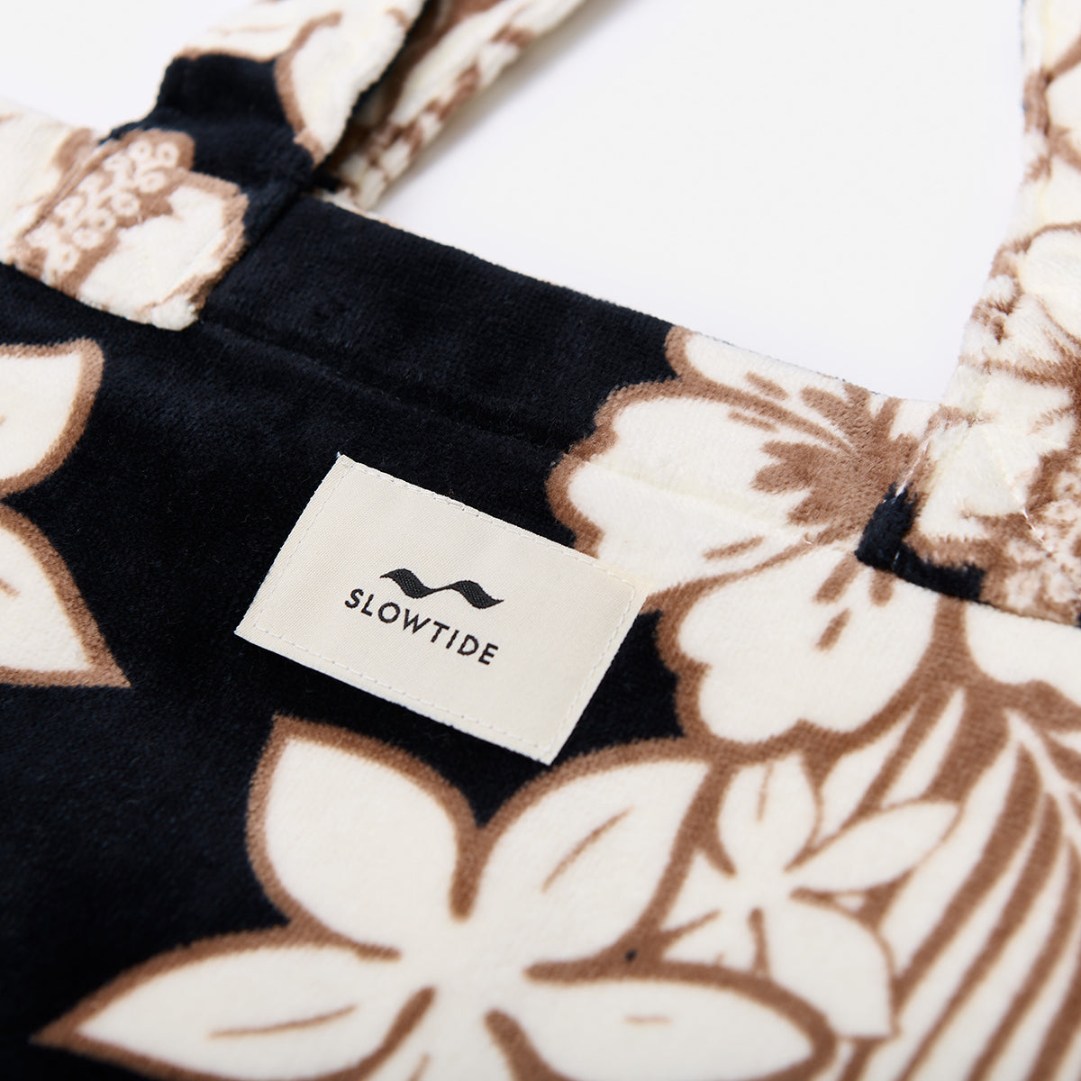 Cotton canvas bag with black floral print, close-up view.