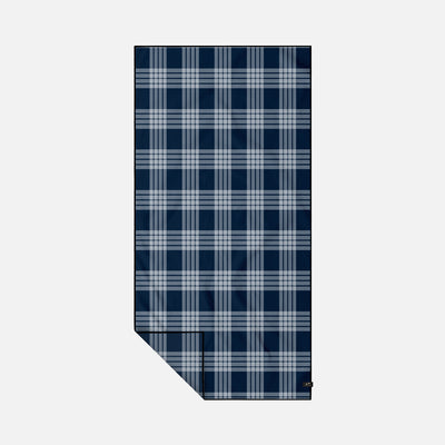 Quick dry towel with blue and white plaid pattern laid flat.