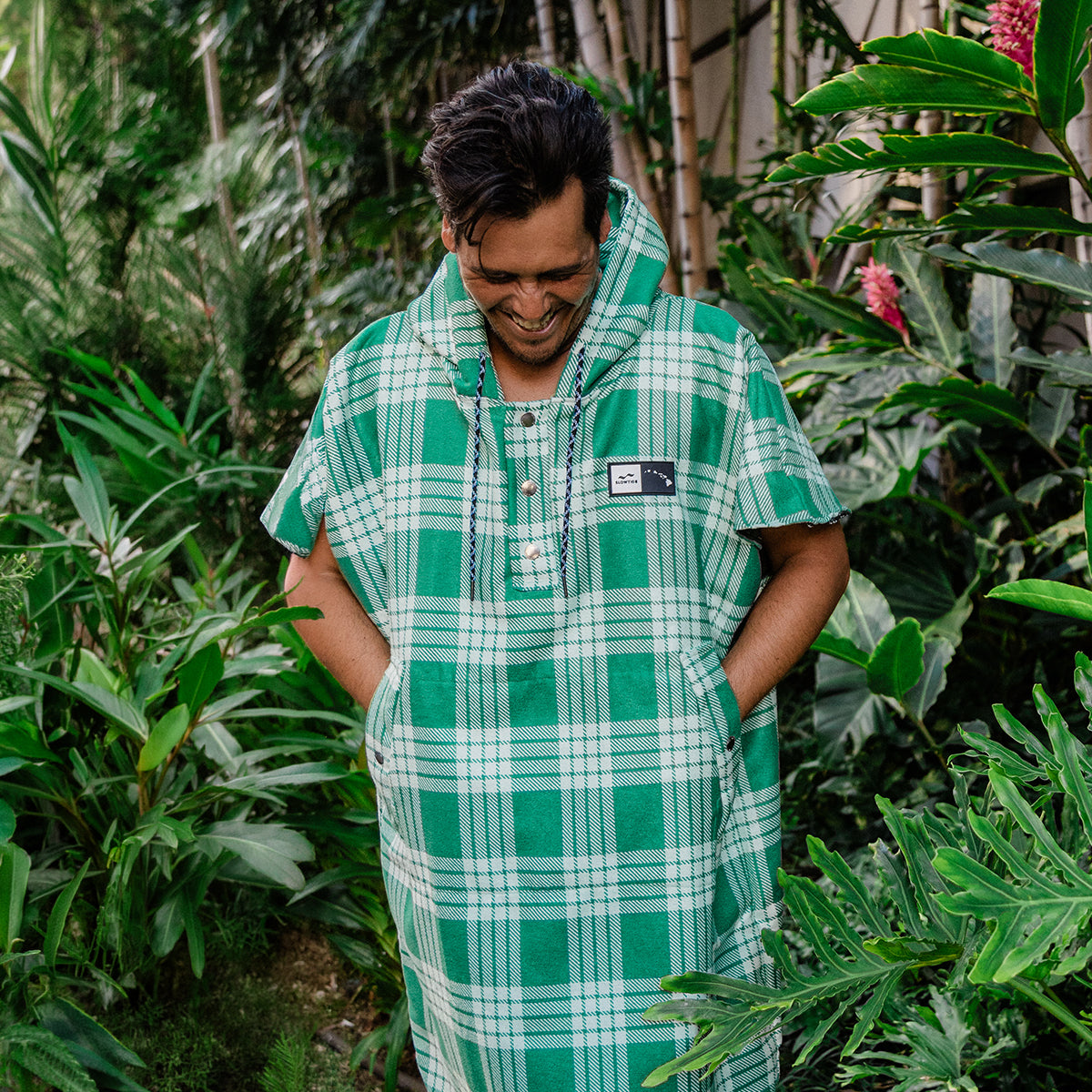 Green plaid hooded changing poncho with high absorbency.