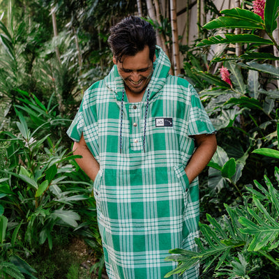 Green plaid hooded changing poncho with high absorbency.