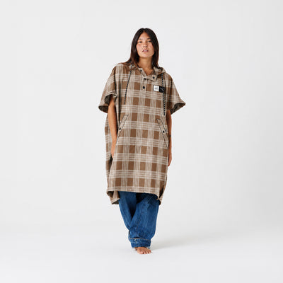 Hooded poncho in recycled tan plaid fabric with a half-zip front.
