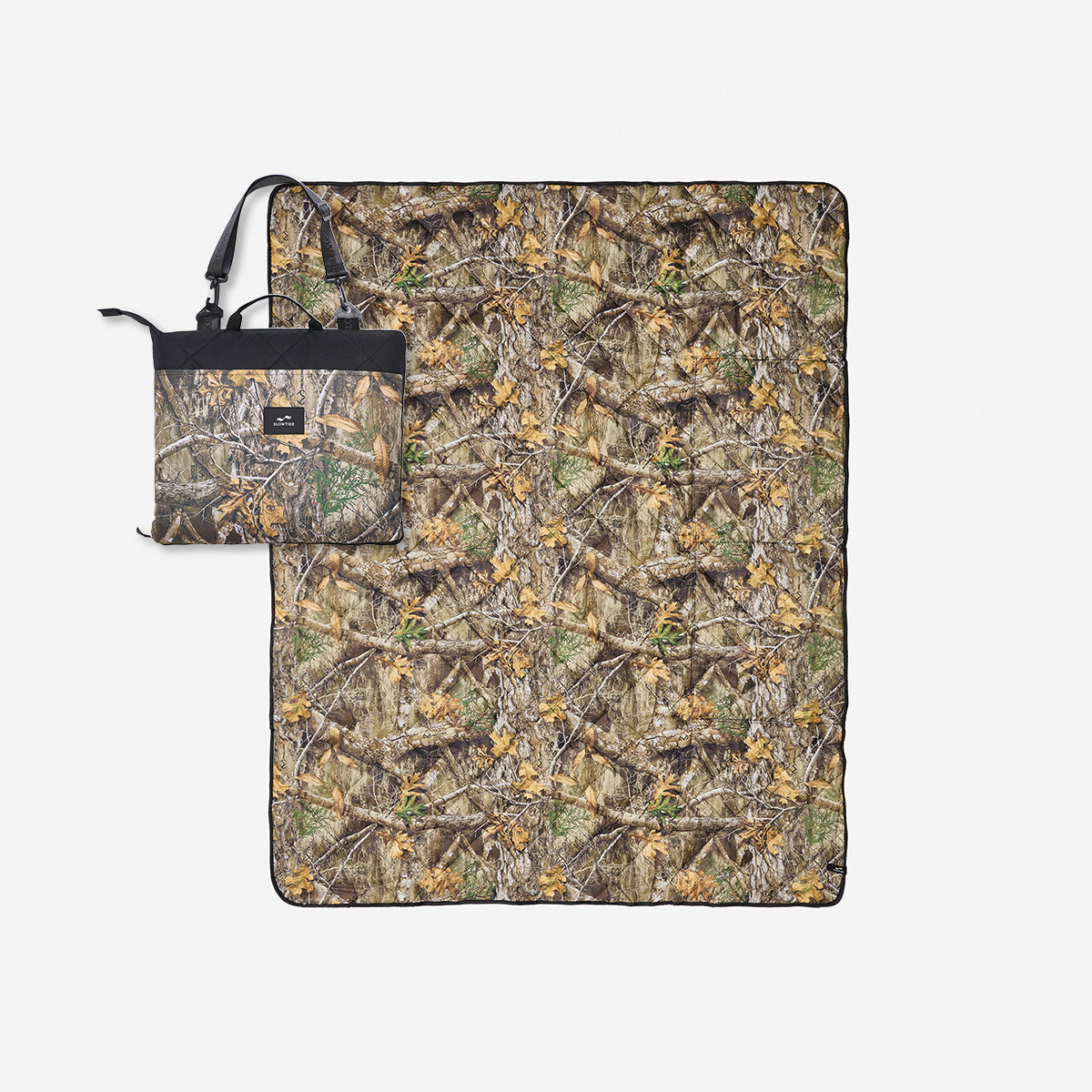 Quilted packable blanket with camo print and matching tote bag.
