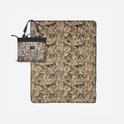 Quilted packable blanket with camo print and matching tote bag.