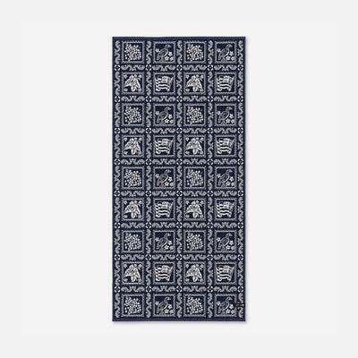 Cotton towel with navy and white animal and floral jacquard grid pattern.