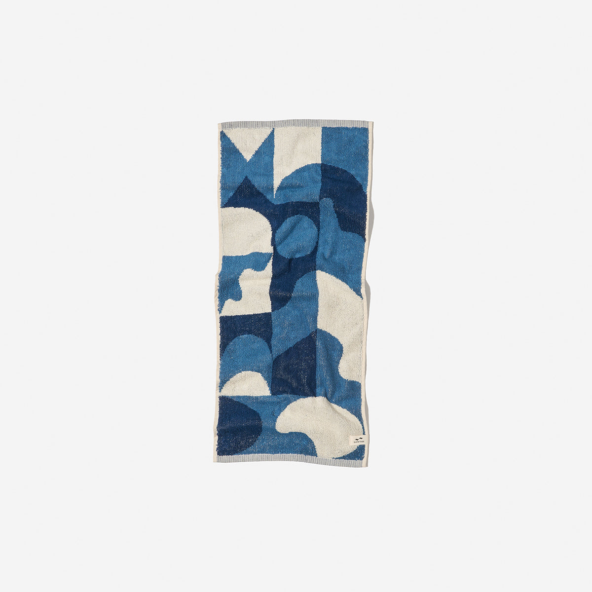 Towel poncho in sand-resistant fabric with blue and cream abstract geometric pattern.