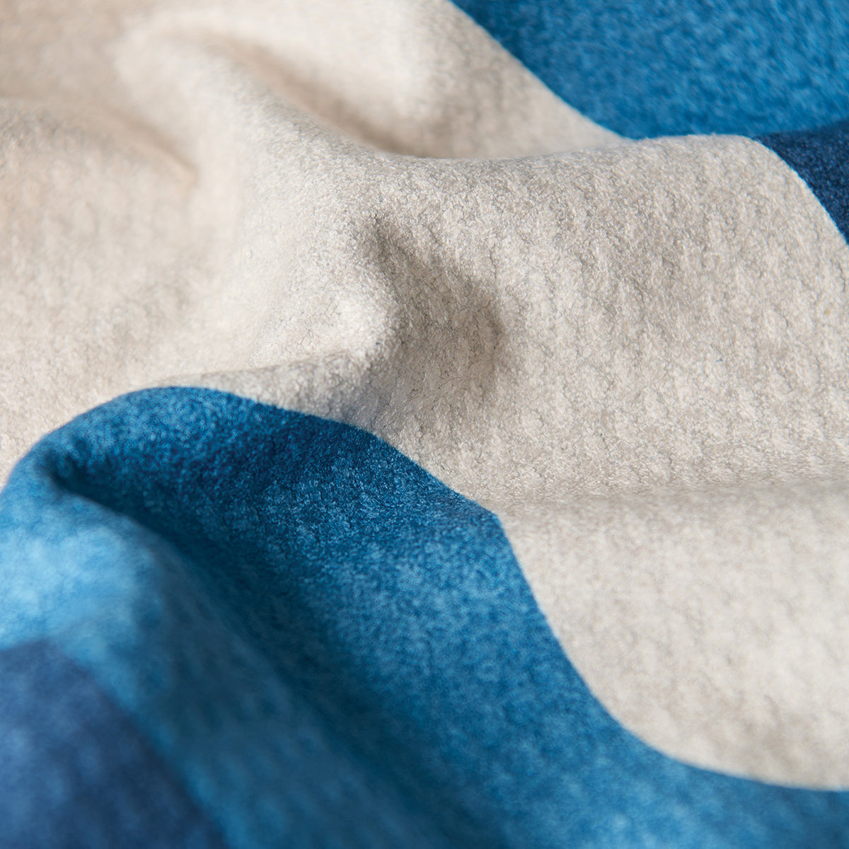 Fleece blanket in blue and cream stripes as a sustainable kitchen towel alternative.
