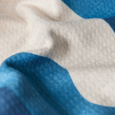 Fleece blanket in blue and cream stripes as a sustainable kitchen towel alternative.