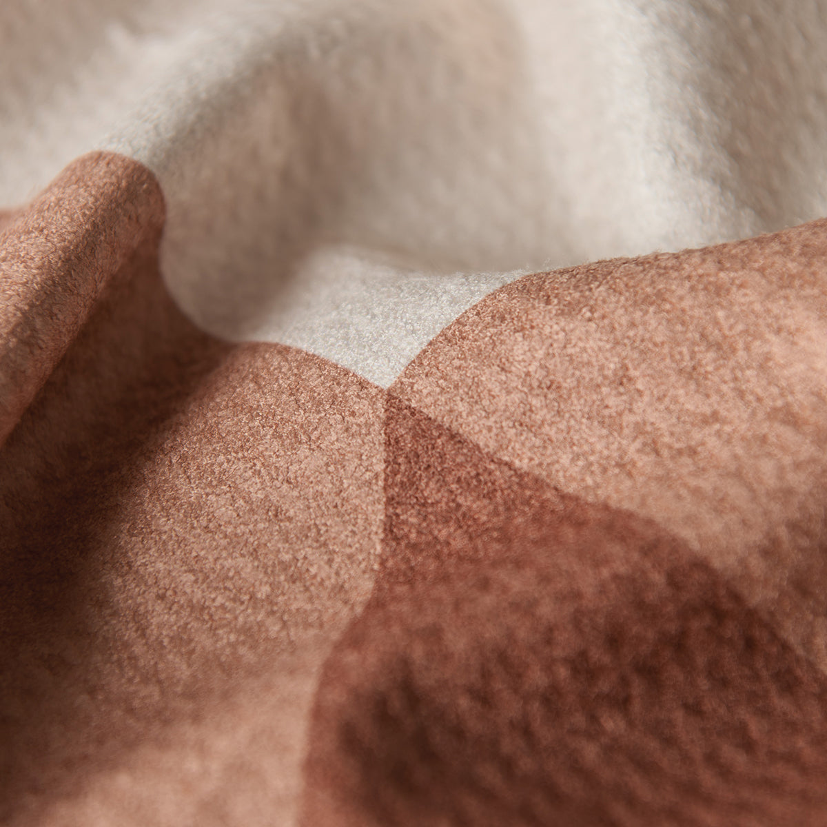 Felted wool kitchen towel with a brown and cream geometric color-block pattern.