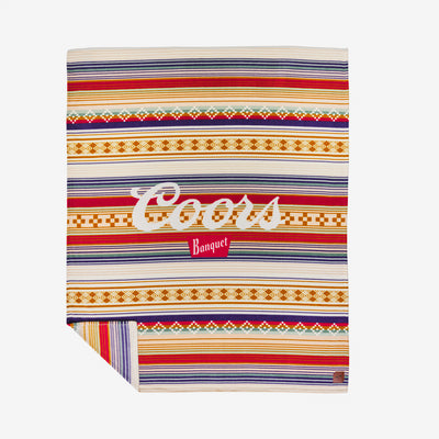 Plush blanket with colorful stripes and bold white and red lettering.