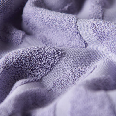 Lavender velour towel with textured folds and absorbent visible loops.