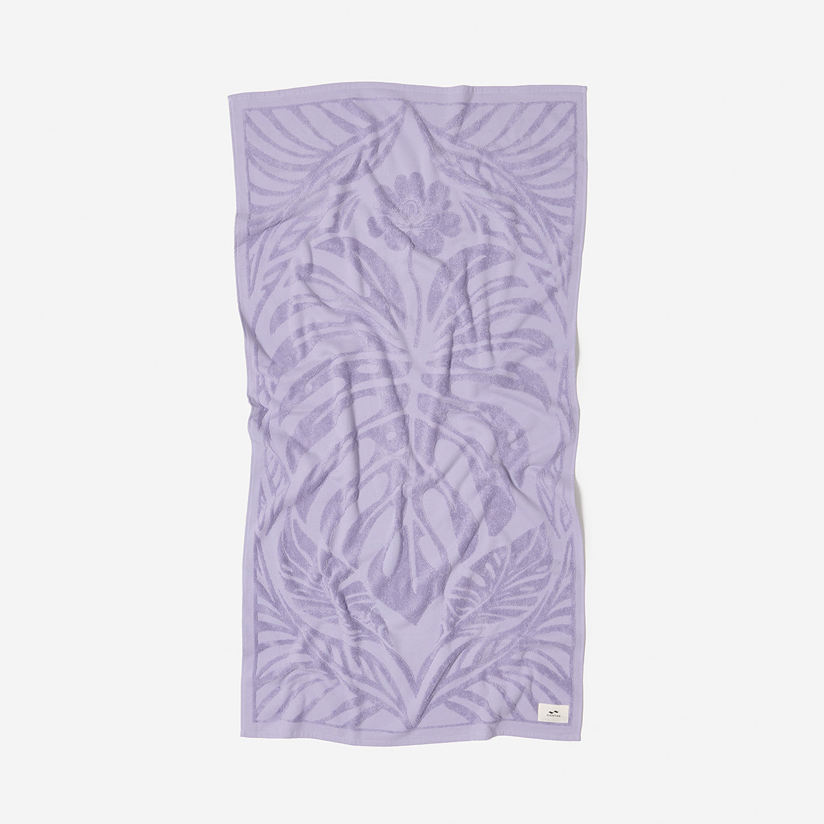Light purple velour towel with textured leaf and floral pattern.