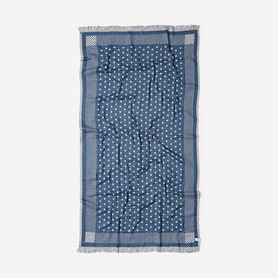 Blue lightweight scarf with white polka dots and fringed edge.